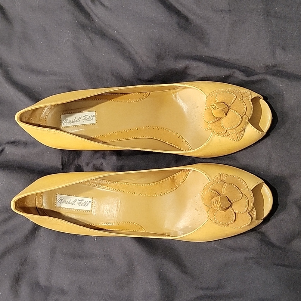 Worn Tan Pumps with Flower Detail on Top of Shoe